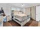 Relaxing main bedroom with natural light, wood-look floors, and access to the closet at 7365 Sandy Creek Dr, Raleigh, NC 27615