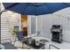 A cozy patio space with seating, a grill, and access to the home's interior at 7365 Sandy Creek Dr, Raleigh, NC 27615