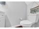 A standard toilet situated in a minimalist bathroom at 7365 Sandy Creek Dr, Raleigh, NC 27615