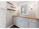 Bathroom vanity with a white sink, decorative shelves, updated lighting, and ample cabinet space at 8116 Bentwood Pl, Raleigh, NC 27615