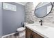 Chic bathroom features an updated sink, stone accent wall, and fixtures at 8116 Bentwood Pl, Raleigh, NC 27615