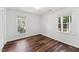 Clean bedroom with hardwood floors and natural light from two windows, with a spacious closet at 8116 Bentwood Pl, Raleigh, NC 27615