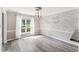 Dining room showcasing a decorative accent wall, modern lighting, and hardwood flooring with natural light at 8116 Bentwood Pl, Raleigh, NC 27615