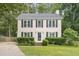 Inviting two-story home featuring a charming front yard with lush greenery at 8116 Bentwood Pl, Raleigh, NC 27615
