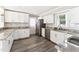 Well-lit kitchen featuring granite counters, white cabinets, and stainless steel appliances at 8116 Bentwood Pl, Raleigh, NC 27615