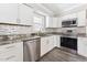 Bright kitchen featuring stainless appliances, granite countertops, and white cabinets at 8116 Bentwood Pl, Raleigh, NC 27615