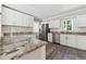 Modern kitchen features stainless steel appliances, granite countertops, and white cabinets at 8116 Bentwood Pl, Raleigh, NC 27615
