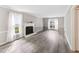 Bright living room featuring hardwood floors, fireplace, and ample natural light at 8116 Bentwood Pl, Raleigh, NC 27615