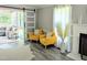 Bright living room with modern decor, barn door, fireplace, and wood-look floors at 8116 Bentwood Pl, Raleigh, NC 27615