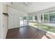 Bright sunroom boasts many windows, wood floors, and access to the deck at 8116 Bentwood Pl, Raleigh, NC 27615