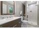 Bathroom with modern vanity, framed mirror, and tiled shower at 821 Stoneybrook Dr, Sanford, NC 27330