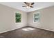 Bedroom with neutral walls and carpeting and two windows at 821 Stoneybrook Dr, Sanford, NC 27330