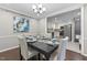 Stylish dining area with modern table set and view into the kitchen at 821 Stoneybrook Dr, Sanford, NC 27330