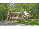 Well-maintained home with a lush front lawn and a welcoming porch at 821 Stoneybrook Dr, Sanford, NC 27330