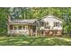 Charming two-story home with brick accents, green lawn, and covered front porch at 821 Stoneybrook Dr, Sanford, NC 27330