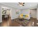 Inviting living room with hardwood floors and neutral decor, leading into dining area at 821 Stoneybrook Dr, Sanford, NC 27330