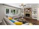 Bright living room with large windows, a fireplace, and built-in shelving at 821 Stoneybrook Dr, Sanford, NC 27330