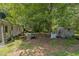 Backyard view of home with an array of trees and a shed at 8635 Old Us 421 S, Bear Creek, NC 27207