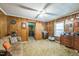 Bedroom features wood paneling, neutral carpet, and ample storage in matching dressers at 8635 Old Us 421 S, Bear Creek, NC 27207