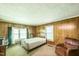 Bedroom featuring natural light, wood paneling, and minimalist decor at 8635 Old Us 421 S, Bear Creek, NC 27207