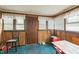 Dining room featuring natural light, wood paneling, and access to exterior door at 8635 Old Us 421 S, Bear Creek, NC 27207