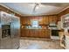 Traditional kitchen featuring wooden cabinets, stainless steel fridge, and a ceiling fan at 8635 Old Us 421 S, Bear Creek, NC 27207