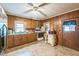 Spacious kitchen showcasing wood cabinets, a bright window over the sink, and durable linoleum flooring at 8635 Old Us 421 S, Bear Creek, NC 27207