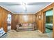 Comfortable living room featuring wood paneling and access to another room at 8635 Old Us 421 S, Bear Creek, NC 27207