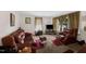 Comfortable living room with leather furniture, carpet, and natural light from the windows at 8635 Old Us 421 S, Bear Creek, NC 27207