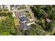 Aerial view of a property nestled among lush trees, showcasing its well-manicured lawn and close proximity to the neighborhood at 911 Canterbury Rd, Raleigh, NC 27607