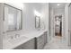 Sleek bathroom with dual sinks, elegant mirrors, and modern fixtures, creating a luxurious and functional space at 911 Canterbury Rd, Raleigh, NC 27607
