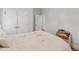 Bright bedroom showcases a double door closet, light walls and hardwood floors at 911 Canterbury Rd, Raleigh, NC 27607