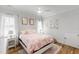 Cozy bedroom with a plush floral bed and sunlit windows, creating a restful retreat at 911 Canterbury Rd, Raleigh, NC 27607