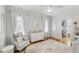 Light-filled Bedroom features a comfortable chair, white dresser, rug and walk-in closet at 911 Canterbury Rd, Raleigh, NC 27607