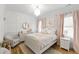 Comfortable bedroom with hardwood floors, complemented by soft pink accents and natural light at 911 Canterbury Rd, Raleigh, NC 27607