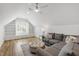 Finished attic space featuring hardwood floors, built-in shelving, and cozy seating area at 911 Canterbury Rd, Raleigh, NC 27607