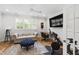 Inviting bonus room featuring a sofa, desk, and exercise bike, perfect for relaxation and fitness at 911 Canterbury Rd, Raleigh, NC 27607