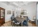 Formal dining room with coffered ceiling, crystal chandelier, wainscoting and stylish blue upholstered chairs at 911 Canterbury Rd, Raleigh, NC 27607