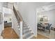 Elegant entryway with a staircase featuring a patterned carpet runner and hardwood herringbone floors at 911 Canterbury Rd, Raleigh, NC 27607