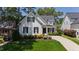 Attractive home with manicured lawn, dark shutters, and a charming front porch at 911 Canterbury Rd, Raleigh, NC 27607