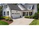 Well-maintained home with lush landscaping, a concrete driveway, and an attached garage at 911 Canterbury Rd, Raleigh, NC 27607