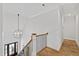 Elegant foyer showcasing hardwood floors, a stylish chandelier, and staircase, creating a grand entrance at 911 Canterbury Rd, Raleigh, NC 27607