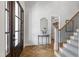 Welcoming foyer with wood floors, stairs with carpet runner, and stylish decor at 911 Canterbury Rd, Raleigh, NC 27607