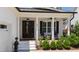 Inviting front porch with rocking chairs, dark shutters, and manicured greenery at 911 Canterbury Rd, Raleigh, NC 27607