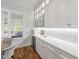 Bright butler's pantry featuring white cabinets, quartz counters, open shelving, and wine fridge at 911 Canterbury Rd, Raleigh, NC 27607