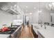 Spacious kitchen with modern appliances, white cabinetry, and a view into the dining room at 911 Canterbury Rd, Raleigh, NC 27607