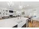 Open-concept kitchen featuring a large island with seating and a view into the living room with fireplace at 911 Canterbury Rd, Raleigh, NC 27607