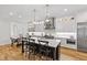 Bright kitchen with island seating, stainless steel appliances, and hardwood flooring at 911 Canterbury Rd, Raleigh, NC 27607