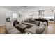 Bright and airy living room with a large sectional sofa, hardwood floors, and an open floor plan to the kitchen at 911 Canterbury Rd, Raleigh, NC 27607