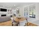 Cozy breakfast nook adjacent to the living room with bright window and fireplace detail at 911 Canterbury Rd, Raleigh, NC 27607
